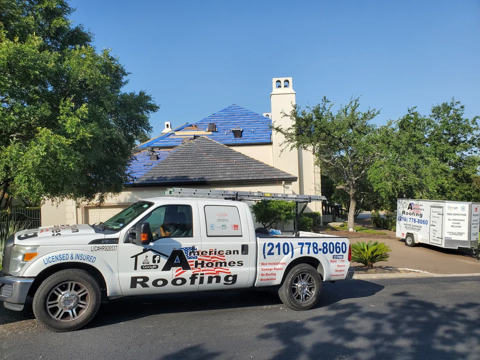 American Homes Roofing truck parked at a house with roof work underway.
