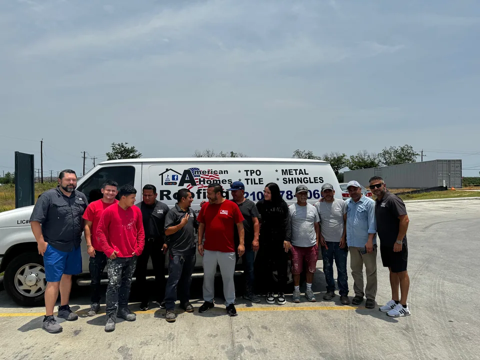 American Homes Roofing crew standing beside a company van.